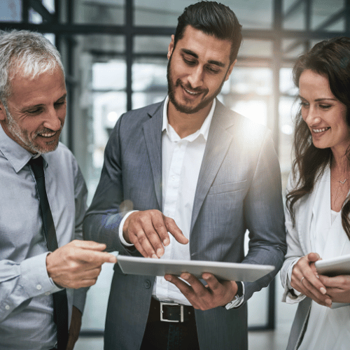 Three professionals around a tablet